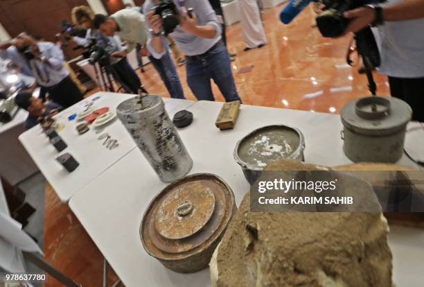 Picture taken on June 19, 2018 in Abu Dhabi shows parts of an improvised explosive device that was hidden inside a fake rock which Emirati armed...