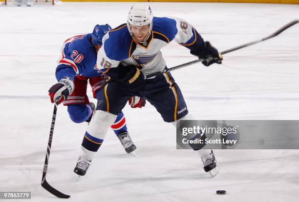 Jay McClement of the St. Louis Blues skates for the puck under pressure by Vinny Prospal of the New York Rangers in the second period on March 18,...