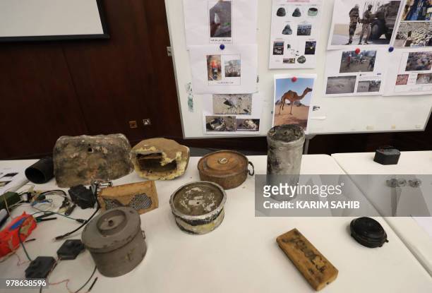 Picture taken on June 19, 2018 in Abu Dhabi shows parts of an improvised explosive device that was hidden inside a fake rock which Emirati armed...