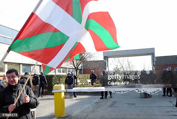 Members of the Joan Anza Committee, a member of the armed Basque separatist group ETA who disappeared nearly a year ago, stand in front of police...