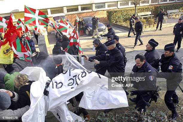 Police officers spray tear gas on members of the Jon Anza Committee, a member of the armed Basque separatist group ETA who disappeared nearly a year...