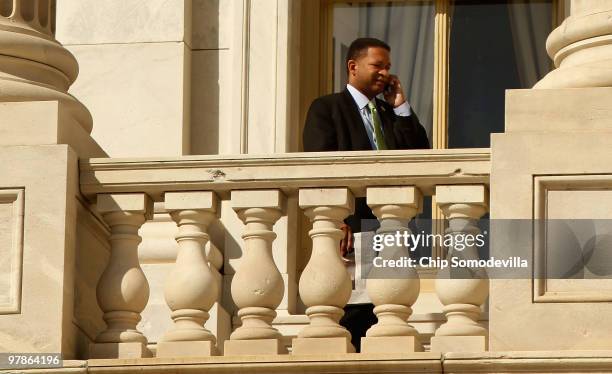 Rep. Artur Davis talks on the phone while standing on a balcony outside the U.S. Capitol March 19, 2010 in Washington, DC. Davis, who is running for...