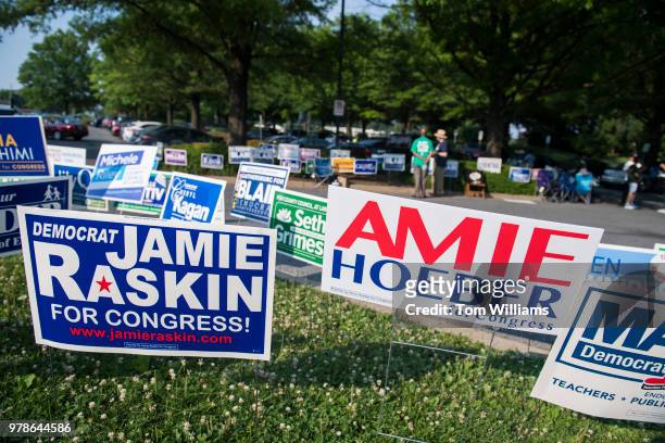Campaign signs are placed outside the Activity Center at Bohrer Park in Gaithersburg, Md., for early voting on June 18, 2018.