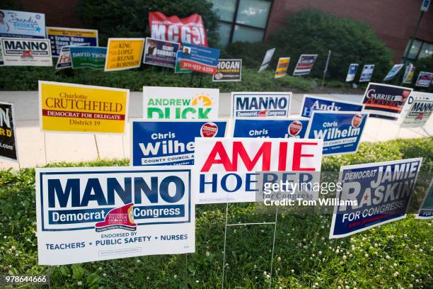 Campaign signs are placed outside the Activity Center at Bohrer Park in Gaithersburg, Md., for early voting on June 18, 2018.