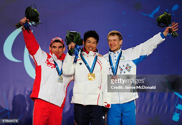 Gold medalist Yoshihiro Nitta of Japan celebrates with silver medalist Kirill Mikhaylov of Russia and bronze medalist Grygorii Vovchynskyi of Ukraine...