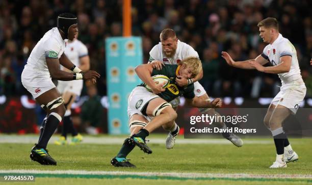 Pieter-Steph du Toit of South Africa is tackled by Brad Shields during the second test match between South Africa and England at Toyota Stadium on...