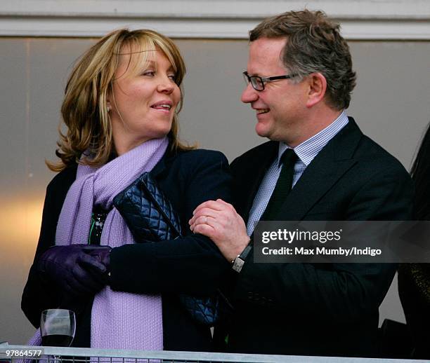 Kirsty Young and husband Nick Jones hug as they attend day 3 of the Cheltenham Horse Racing Festival on March 18, 2010 in Cheltenham, England.