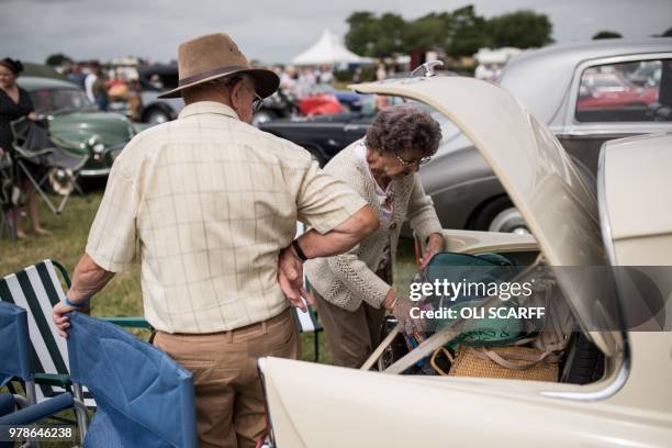 Couple retrieve items from the boot of their classic car, displayed on the first day of The Royal Cheshire County Show at Tabley, near Knutsford,...