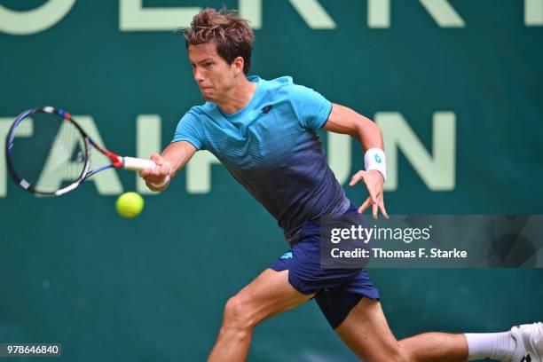 Aljaz Bedene of Slovenia plays a forehand in his match against Reger Federer of Switzerland during day two of the Gerry Weber Open at Gerry Weber...