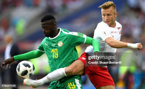 Mbaye Niang of Senegal is challenged by Jakub Blaszczykowski of Poland during the 2018 FIFA World Cup Russia group H match between Poland and Senegal...