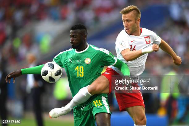 Mbaye Niang of Senegal is challenged by Jakub Blaszczykowski of Poland during the 2018 FIFA World Cup Russia group H match between Poland and Senegal...