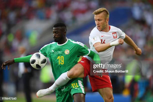 Mbaye Niang of Senegal is challenged by Jakub Blaszczykowski of Poland during the 2018 FIFA World Cup Russia group H match between Poland and Senegal...