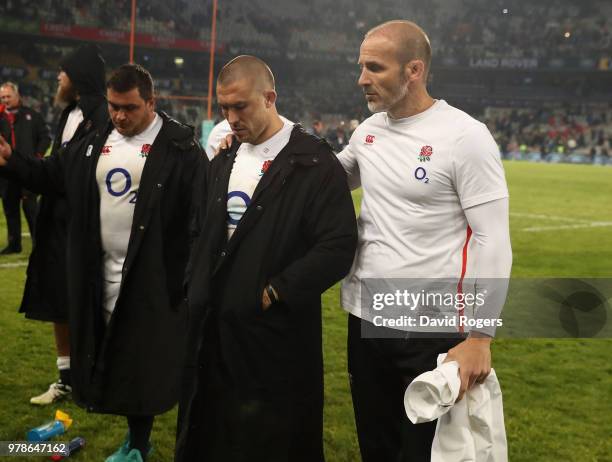 Mike Brown of England is consoled by defence coach Paul Gustard after their defeat during the second test match between South Africa and England at...