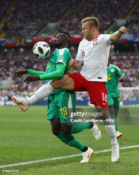 Mbaye Niang of Senegal is tackled by Jakub Blaszczykowski of Poland during the 2018 FIFA World Cup Russia group H match between Poland and Senegal at...