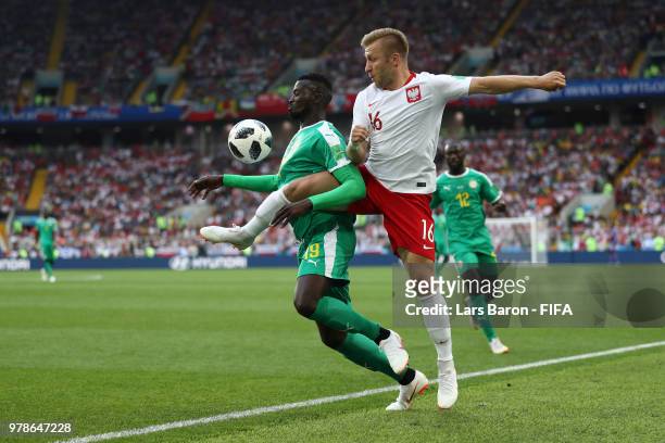 Mbaye Niang of Senegal is tackled by Jakub Blaszczykowski of Poland during the 2018 FIFA World Cup Russia group H match between Poland and Senegal at...