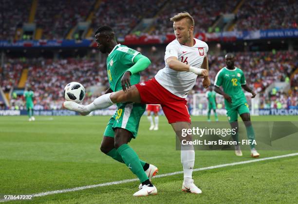 Mbaye Niang of Senegal is tackled by Jakub Blaszczykowski of Poland during the 2018 FIFA World Cup Russia group H match between Poland and Senegal at...