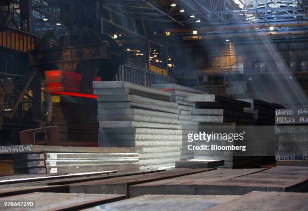 Steel slabs sit in a storage area in the converter shop at the Novolipetsk Steel PJSC plant, operated by NLMK Group, in Lipetsk, Russia, on Monday,...