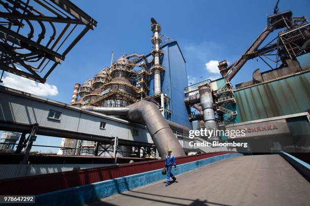 Worker walks through the blast furnace complex at the Novolipetsk Steel PJSC plant, operated by NLMK Group, in Lipetsk, Russia, on Monday, June 18,...