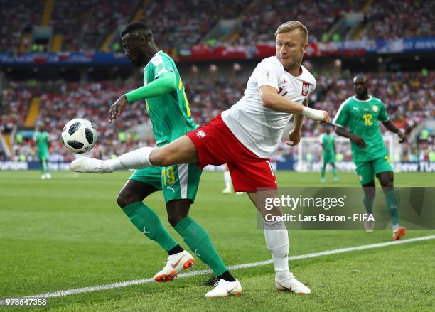 Mbaye Niang of Senegal is tackled by Jakub Blaszczykowski of Poland during the 2018 FIFA World Cup Russia group H match between Poland and Senegal at...