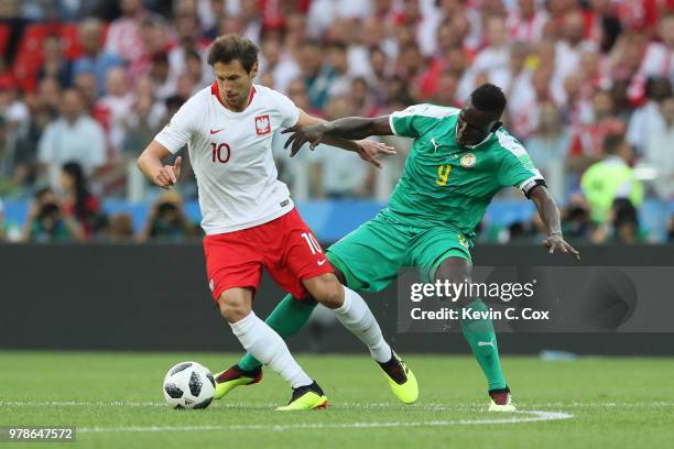 Grzegorz Krychowiak of Poland is challenged by Mame Diouf of Senegal during the 2018 FIFA World Cup Russia group H match between Poland and Senegal...