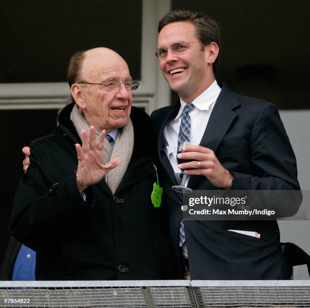 Rupert Murdoch hugs son James Murdoch as they watch the racing on 'Ladies Day', day 3 of the Cheltenham Horse Racing Festival on March 18, 2010 in...