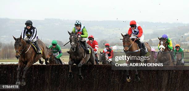 Imperial Commander ridden by Paddy Brennan , Ruby Walsh riding Kauto Star and Carruthers ridden by Mattie Batchelor go over the first jump during the...
