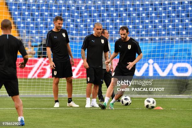 Uruguay's Cristhian Stuani, Maximiliano Pereira and Diego Godin take part in a training session at the Rostov Arena in Rostov-On-Don on June 19 on...