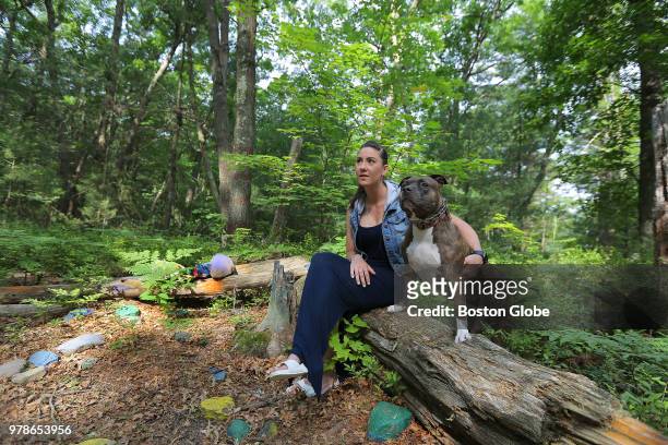Alison Reeves takes her 7-year-old dog Faith for a walk in the Blue Hills Reservation in Randolph, MA on June 18, 2018. Faith also belonged to her...
