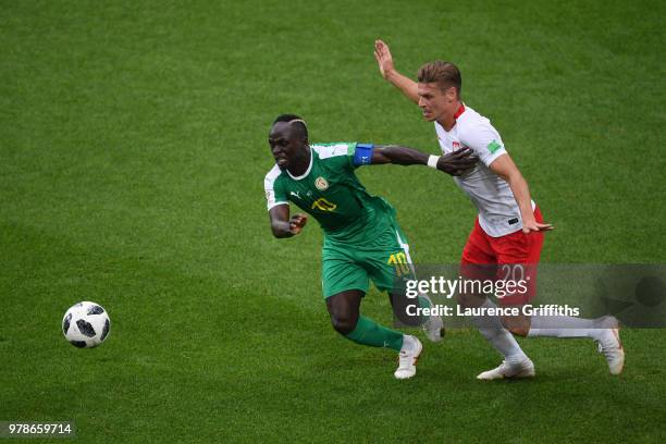 Sadio Mane of Senegal challenge for the ball with Lukasz Piszczek of Poland during the 2018 FIFA World Cup Russia group H match between Poland and...