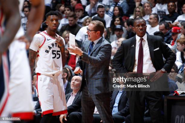 Head Coach Dwane Casey of the Toronto Raptors looks on as Nick Nurse speaks with Delon Wright during the game against the Washington Wizards in Game...