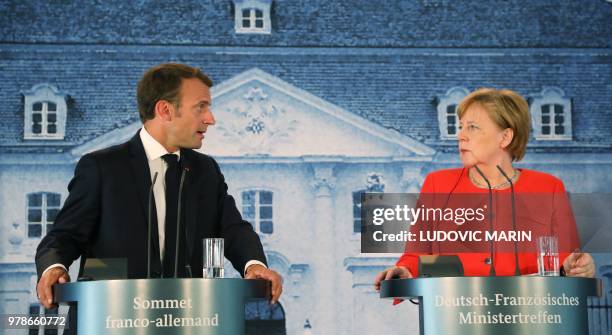 French President Emmanuel Macron delivers a speech during a press conference after bilateral talks with German Chancellor on June 19 at the Meseberg...