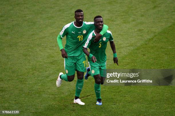 Idrissa Gana Gueye of Senegal celebrates with team mate Mbaye Niang after Thiago Cionek of Poland scored and own goal to put Senegal in front 1-0...