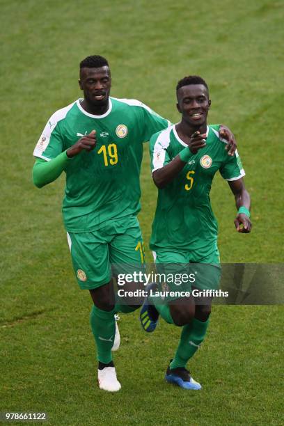 Idrissa Gana Gueye of Senegal celebrates with team mate Mbaye Niang after Thiago Cionek of Poland scored and own goal to put Senegal in front 1-0...