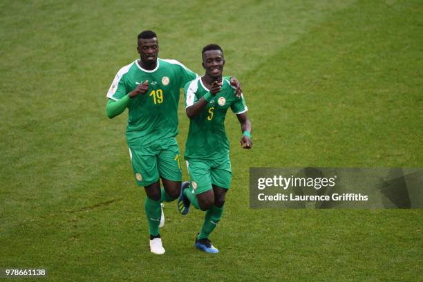 Idrissa Gana Gueye of Senegal celebrates with team mate Mbaye Niang after Thiago Cionek of Poland scored and own goal to put Senegal in front 1-0...