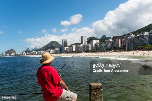 fisherman on arpoador beach, rio de janeiro - arpoador beach stock pictures, royalty-free photos & images