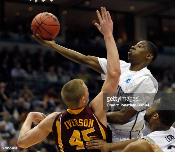 Jordan Crawford of the Xavier Musketeers goes up for a shot over Colton Iverson of the Minnesota Golden Gophers in the first half during the first...
