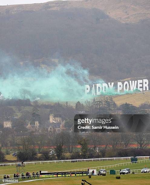 Green smoke is released from the Paddy Power sign overlooking the racecourse during the Gold Cup race at the Cheltenham Festival on March 19, 2010 in...