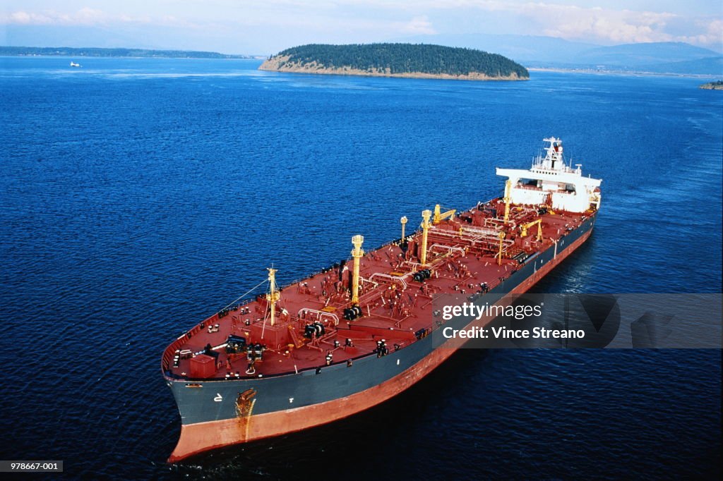 Tanker anchored offshore, land in background