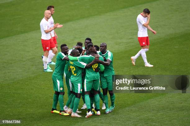 Idrissa Gana Gueye of Senegal celebrates with team-mates after Thiago Cionek of Poland scored and own goal to put Senegal in front 1-0 during the...