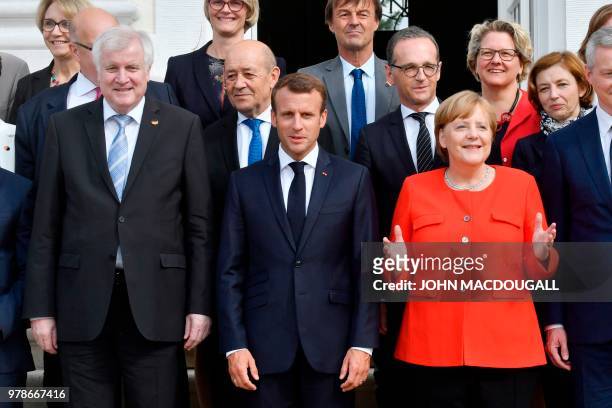 German Chancellor Angela Merkel and French President Emmanuel Macron pose with their Ministers, including German Interior Minister Horst Seehofer ,...