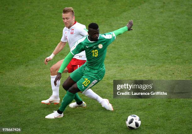 Mbaye Niang of Senegal challenge for the ball with Jakub Blaszczykowski of Poland during the 2018 FIFA World Cup Russia group H match between Poland...