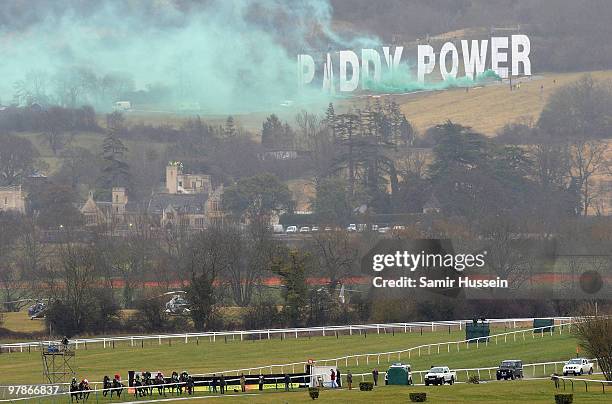 Green smoke is released from the Paddy Power sign overlooking the racecourse during the Gold Cup race at the Cheltenham Festival on March 19, 2010 in...