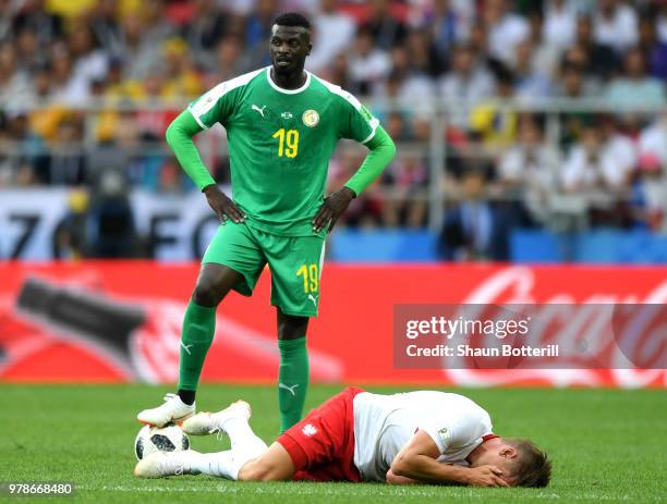 Mbaye Niang of Senegal looks on while Piotr Zielinski of Poland lies on the pitch injured during the 2018 FIFA World Cup Russia group H match between...