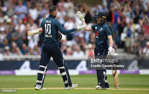 Alex Hales of England celebrates reaching his century with captain Eoin Morgan during the 3rd Royal London ODI match between England and Australia at...
