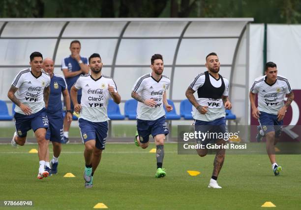 Lionel Messi of Argentina and teammates warm up during a training session at Stadium of Syroyezhkin sports school on June 19, 2018 in Bronnitsy,...