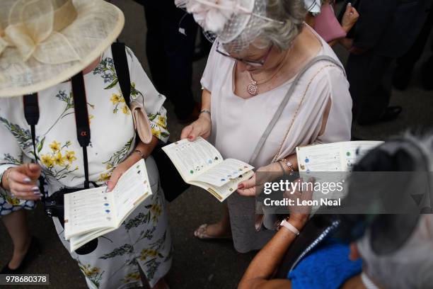 Racegoers check the runners and betting odds on a race during day one of Royal Ascot at Ascot Racecourse on June 19, 2018 in Ascot, United Kingdom....