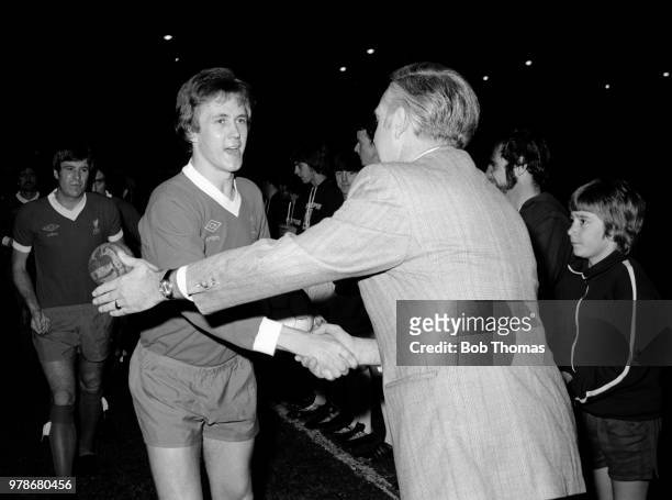 Phil Neal of Liverpool shakes hands with former manager Dave Bowen before the Dave Bowen Testimonial Match at the County Ground on November 22, 1976...