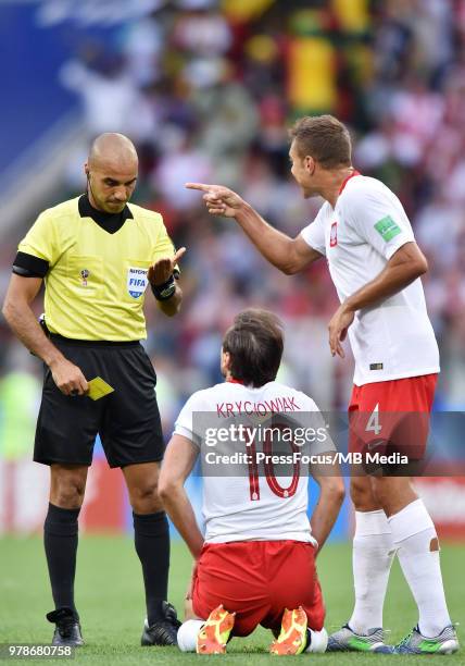 Referee Nawaf Shukralla shows the yellow card to Grzegorz Krychowiak of Poland during the 2018 FIFA World Cup Russia group H match between Poland and...