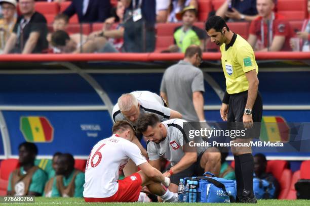 Jakub Blaszczykowski of Poland provided by massage therapists during the 2018 FIFA World Cup Russia group H match between Poland and Senegal at...