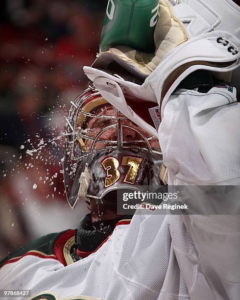 Josh Harding of the Minnesota Wild cools off during an NHL game against the Detroit Red Wings at Joe Louis Arena on March 11, 2010 in Detroit,...